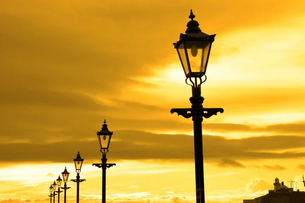 Row of vintage lamps at sunset