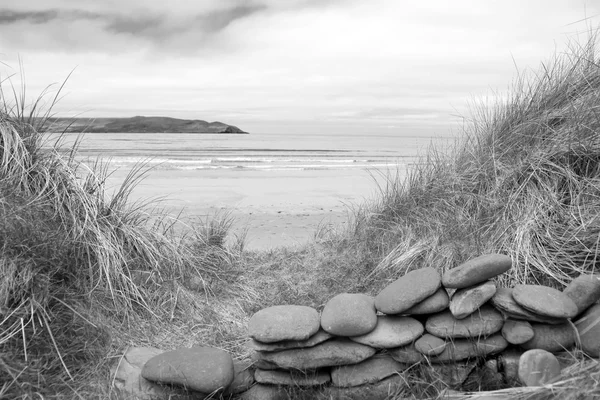 Stone wall shelter on a beautiful beach in black and white