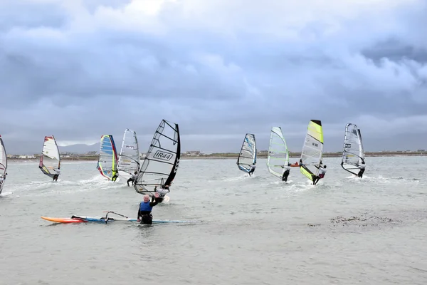 Waving wind surfer racing in the Atlantic storm winds