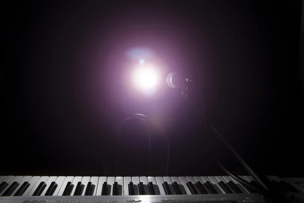 Microphone  and piano in dark background