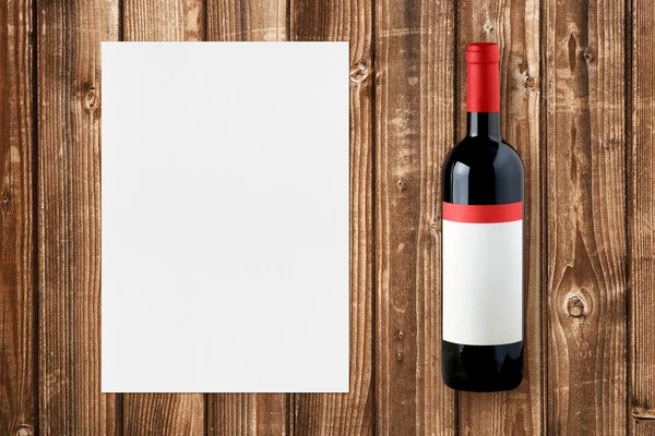 Wine bottle and paper for wine list on wooden background