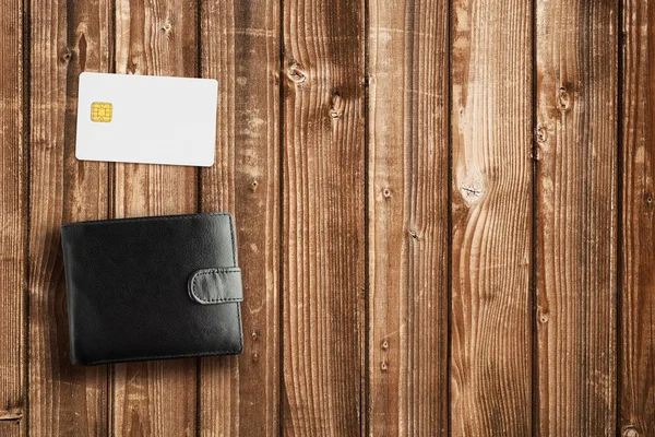 Wallet and credit card on wooden table