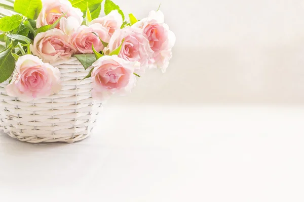 Beautiful, pink roses in a white basket close up