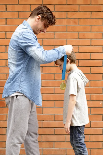 Father and son  happy gold medal - champion, winner