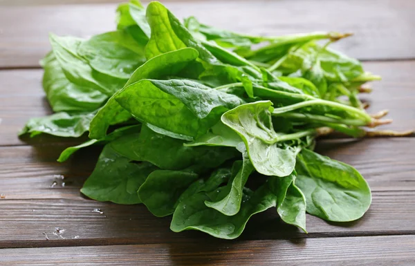 Natural organic green spinach on a wooden table