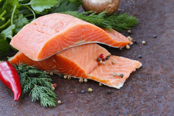 Fresh salmon (red fish) fillet with herbs, spices and vegetables - healthy food