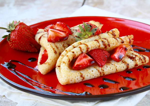 Sweet thin french style crepes, served with strawberries