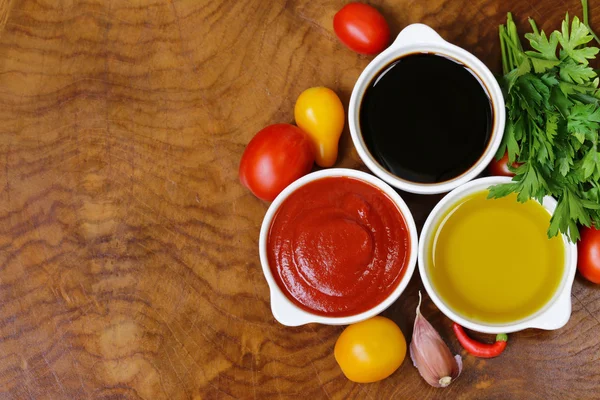Traditional Italian sauces - balsamic vinegar, tomato sauce and olive oil