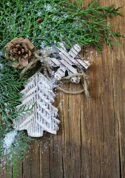 Fir branches arborvitae with wooden Christmas decorations