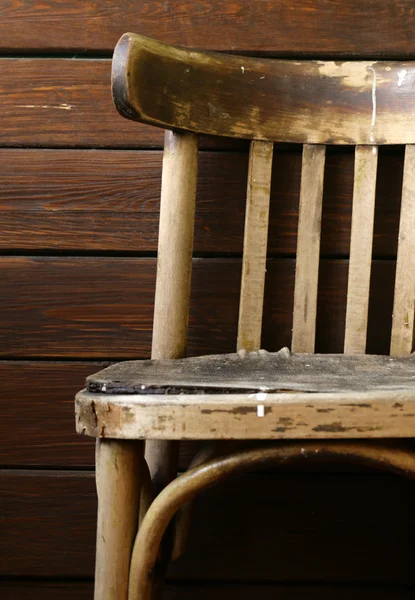 Old grunge vintage chair on a wooden background