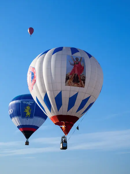 Three colored balloons in blue sky