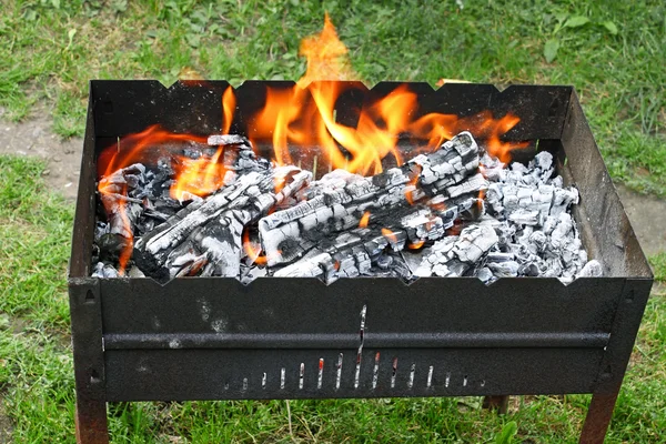 Fire in a container for cooking meat