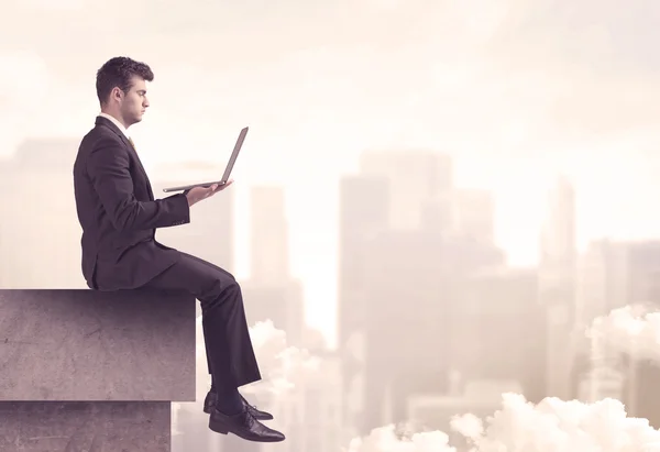 Peaceful sales guy sitting on roof top