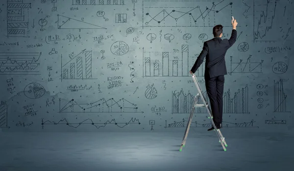 Man on ladder drawing charts