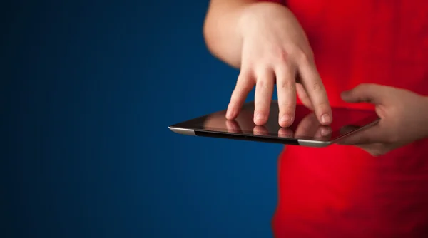 Close up of hand holding digital touchpad tablet device