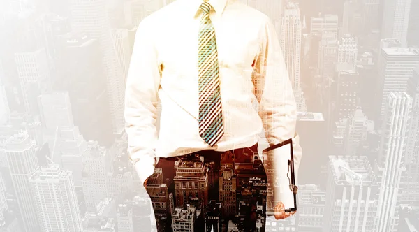 Business person with warm color overlay of city background