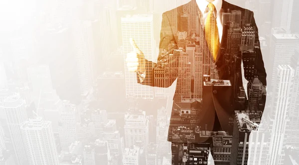 Business person with warm color overlay of city background