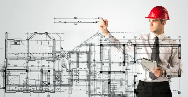 An young architect drawing a house plan