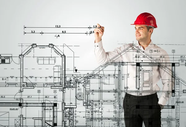 An young architect drawing a house plan