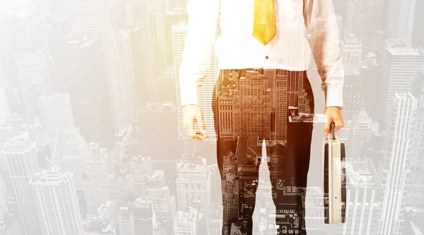 Business person with warm color overlay of city background