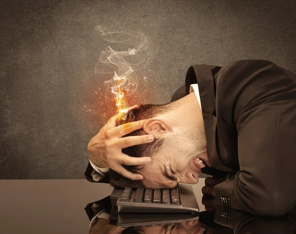 Sad business person\'s head catching fire