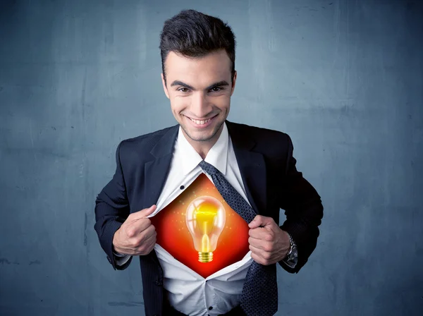 Businessman ripping off shirt and idea light bulb appears