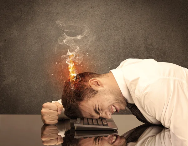 Sad business person's head catching fire