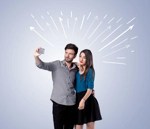 Cute couple taking selfie with arrows