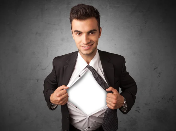 Businessman tearing off his shirt with white copyspace on chest