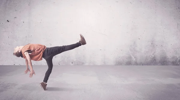 Pretty urban dancer with empty background