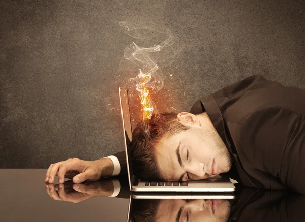 Sad business person\'s head catching fire