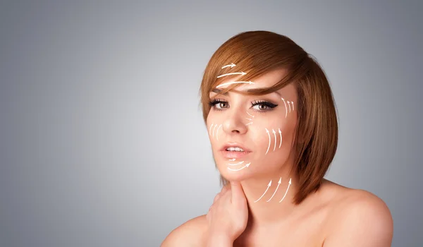 Beautiful girl with facial arrows on her skin
