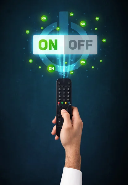 Hand with remote control and on-off signals