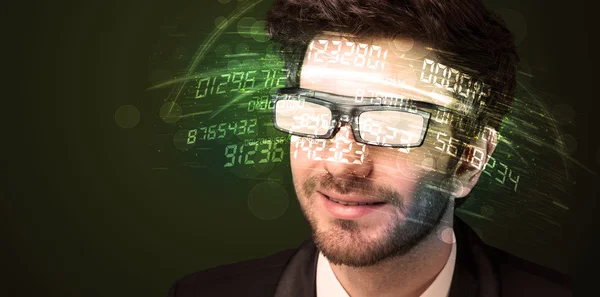 Business man looking at high tech number calculations