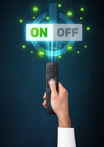 Hand with remote control and on-off signals