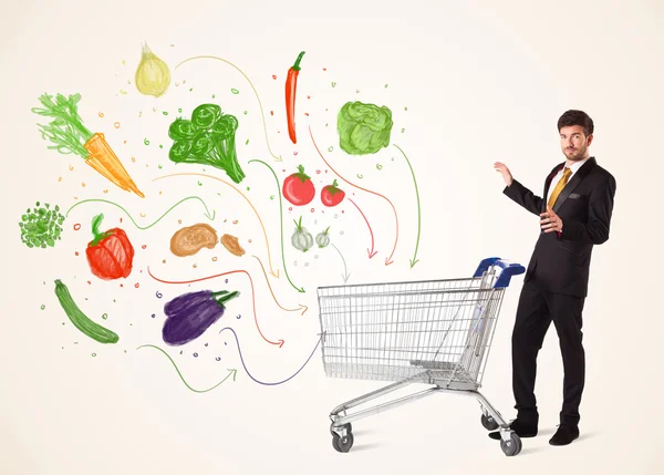 Businessman with shopping cart with vegetables