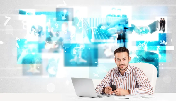 Business person at desk with modern tech images at background