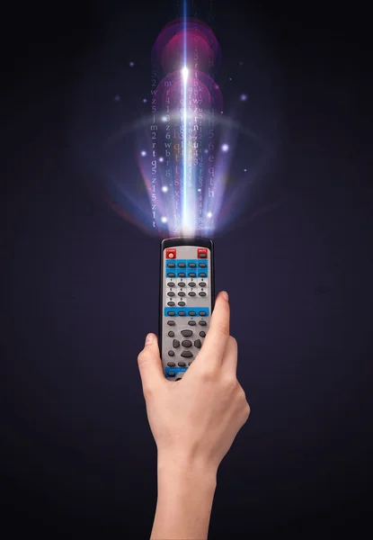 Hand with remote control and shining numbers