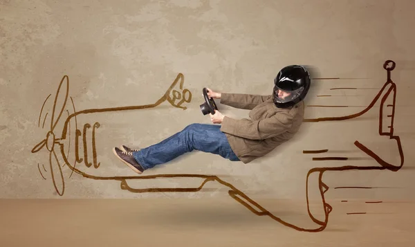 Funny pilot driving a hand drawn airplane on the wall