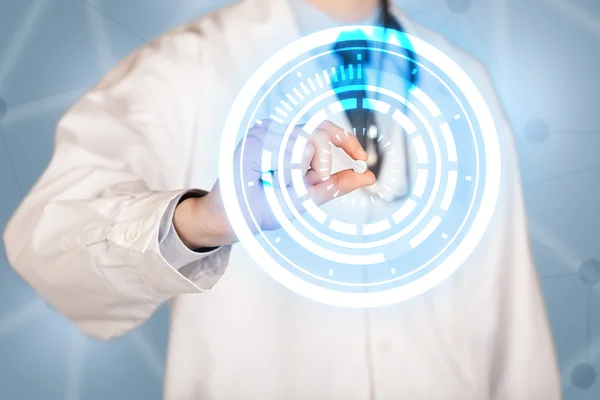 Male doctor holding a pill with glowing circles