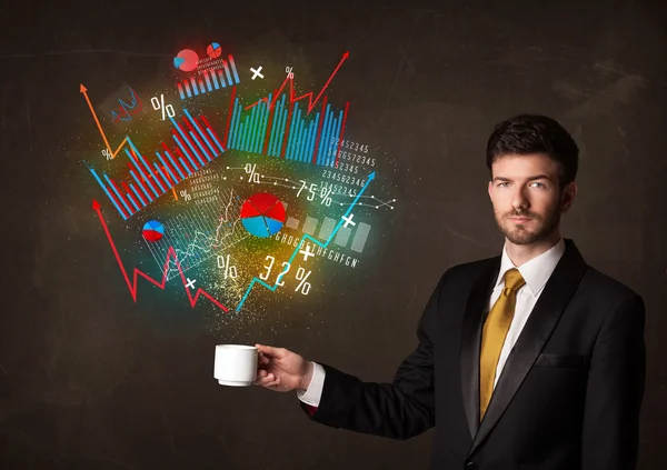 Businessman holding a white cup with diagrams and graphs
