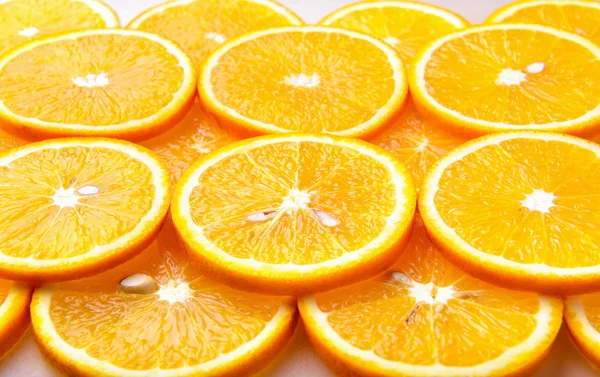 Fresh orange slices, orange background
