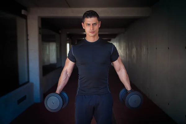 Strong healthy man with weights