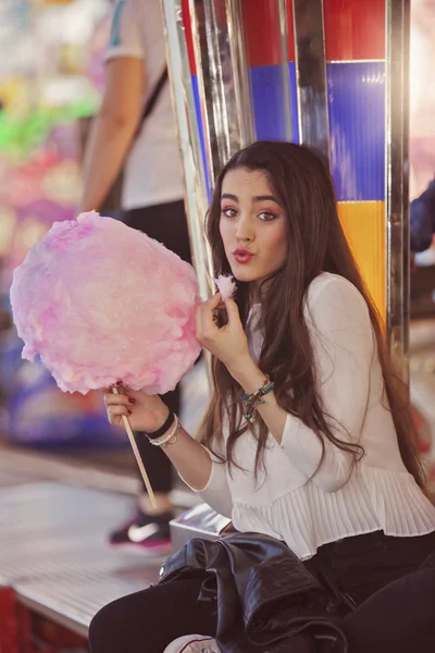 Teen at fair eating cotton candy floss