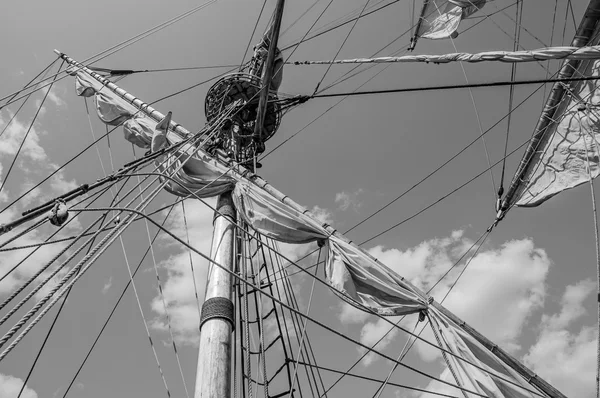 Mast with sails of an old sailing vessel, black and white photo