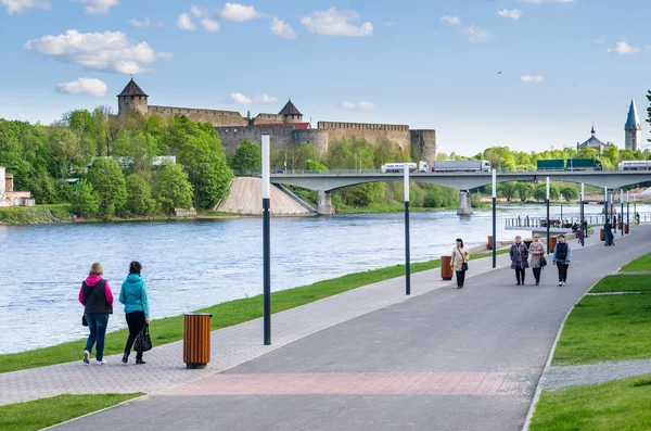 Narva River embankment with vacationers people and the border of Russia and the European Union