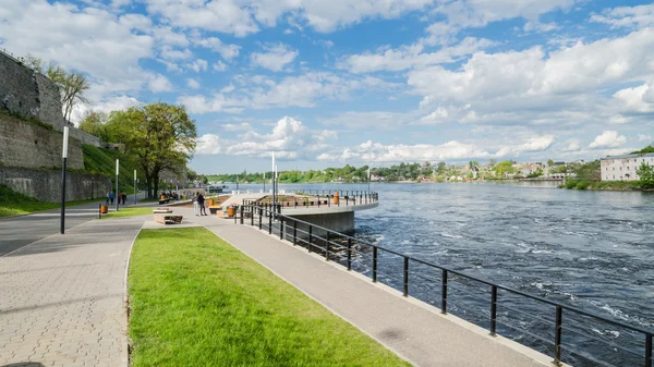 Narva River embankment with vacationers people and the border of Russia and the European Union