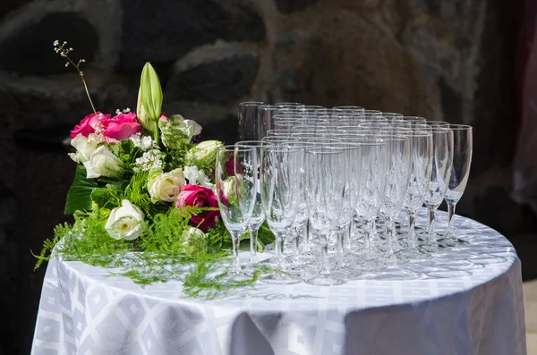 Bouquet of flowers and wine glasses for a wedding table