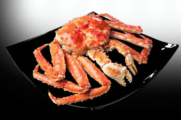 Red king crab served on black plate