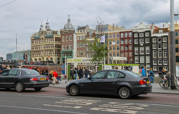 Cars and people on the waterfront in Amsterdam